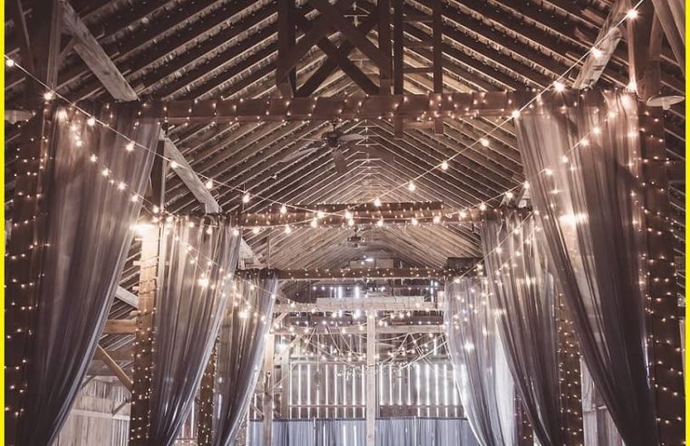 Create a magical ambiance with wood arches adorned with enchanting lighting for your wedding